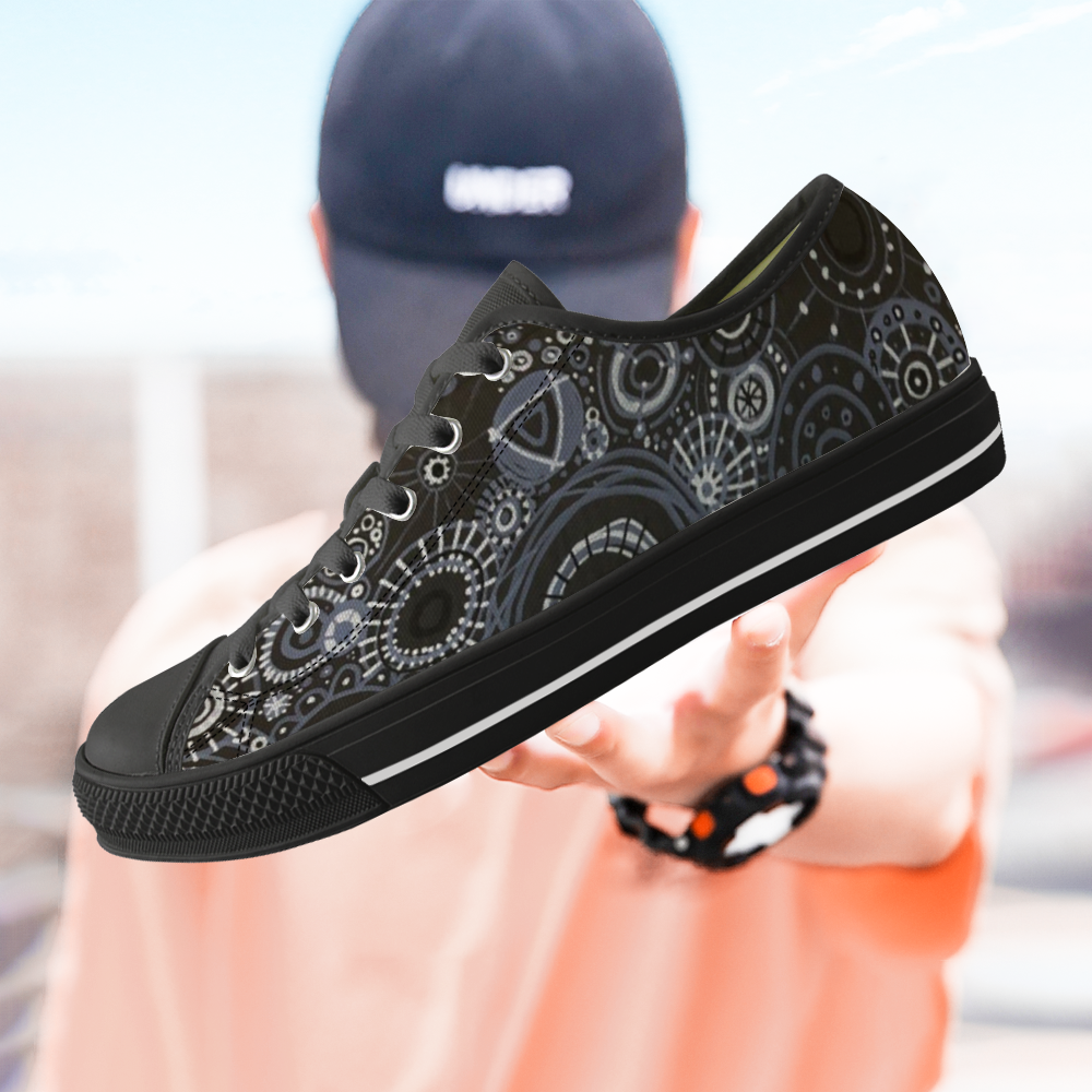 Sneakers with black features and all over pattern in greys and blacks. with model