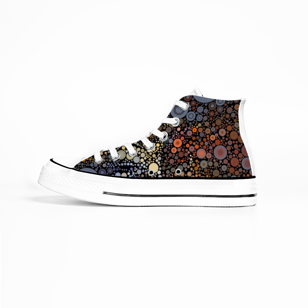 Side view Gymboot style canvas shoe, white sole and laces, an explosion of fiery dots on black background