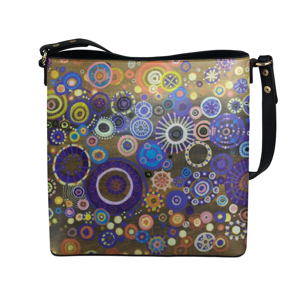 Shoulder bag with brilliant circles and interlocking stars over mustard painting