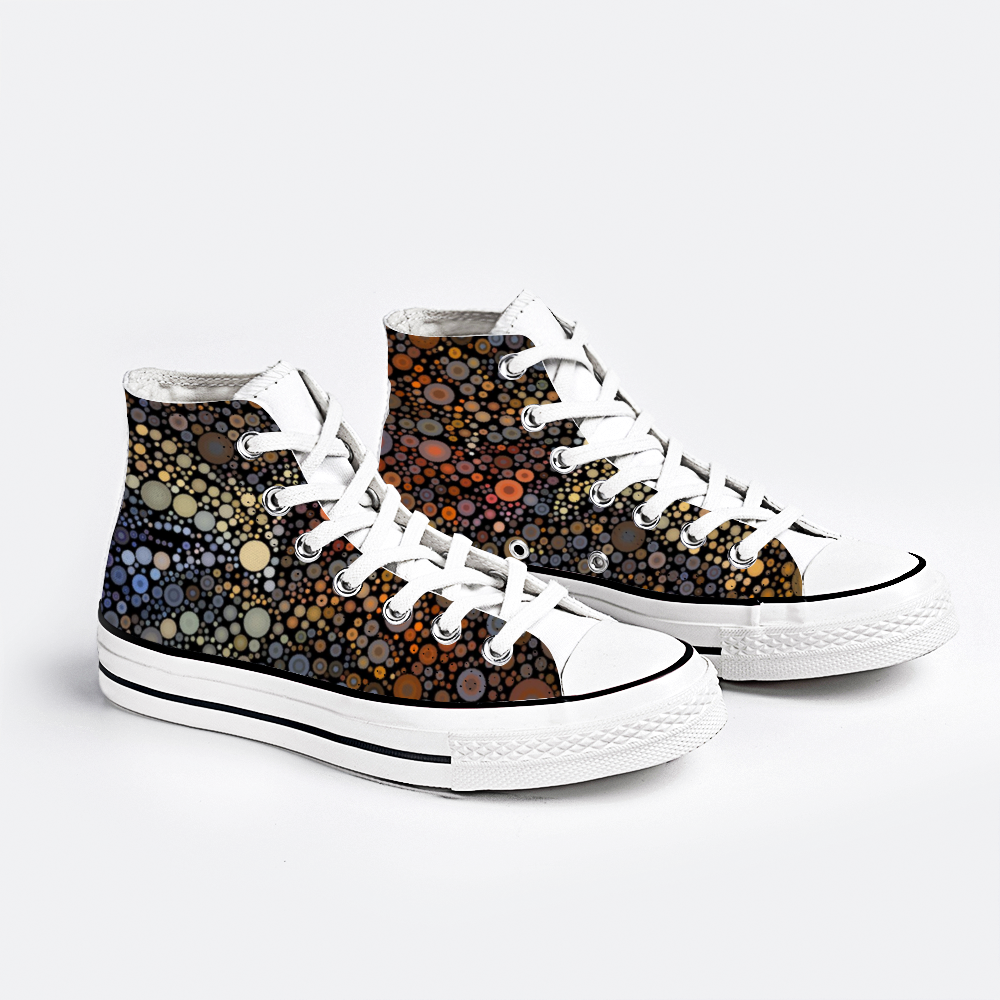 Pair view Gymboot style canvas shoe, white sole and laces, an explosion of fiery dots on black background