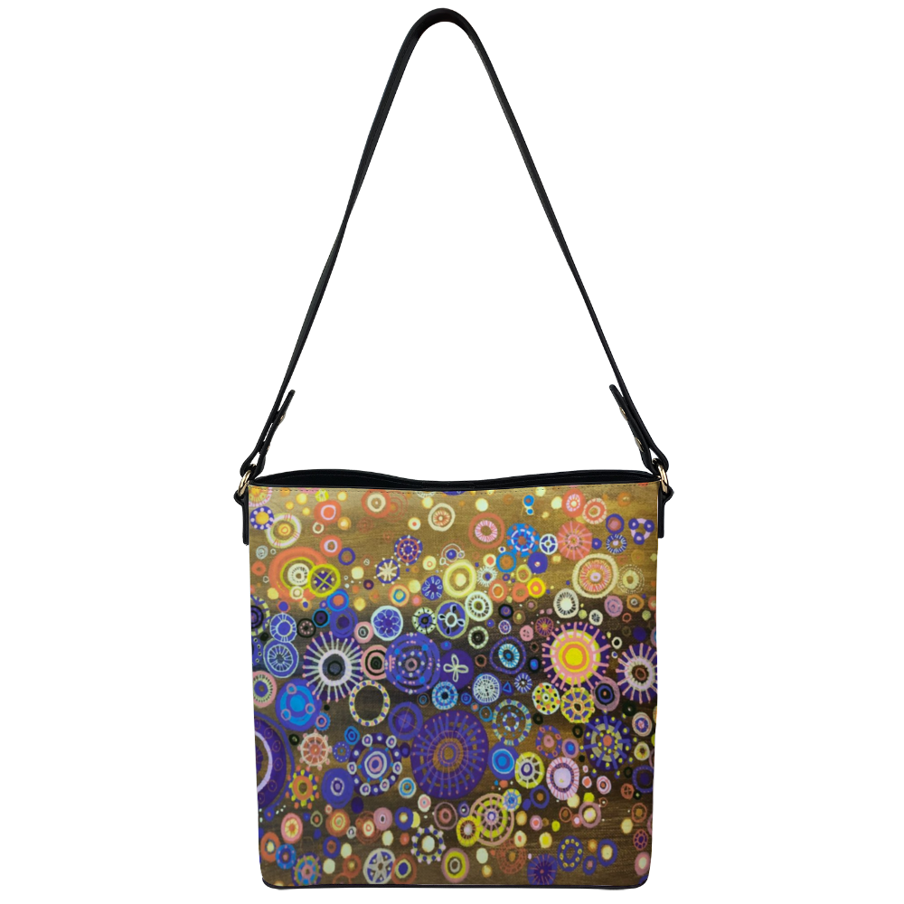 Shoulder bag with brilliant circles and interlocking stars over mustard painting